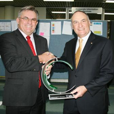 Picture of The Department's Director of Telecommunication Glenn Veen proudly accepts the national award from Chief Judge of the iAwards Jim Ellis.